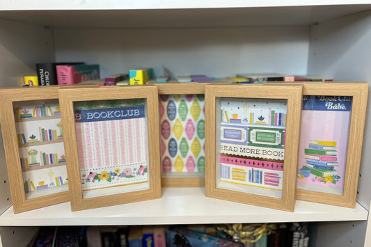 Shadow Boxes with colorful prints on a shelf