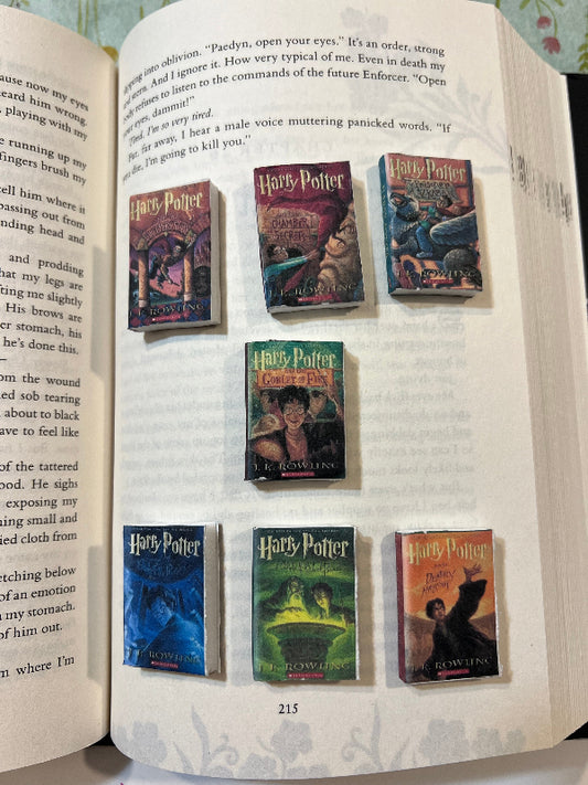 Open book with 'Harry Potter' book covers displayed on the pages