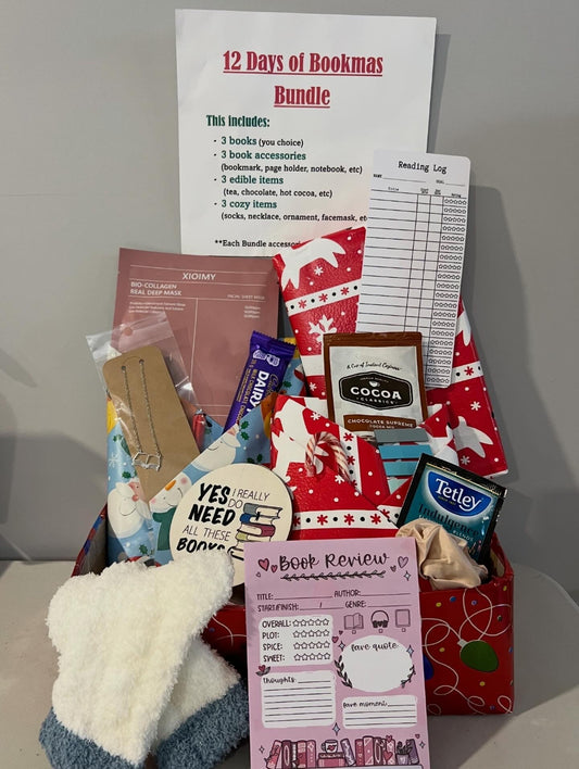 Gift basket with books, snacks, and stationery items on a white surface.