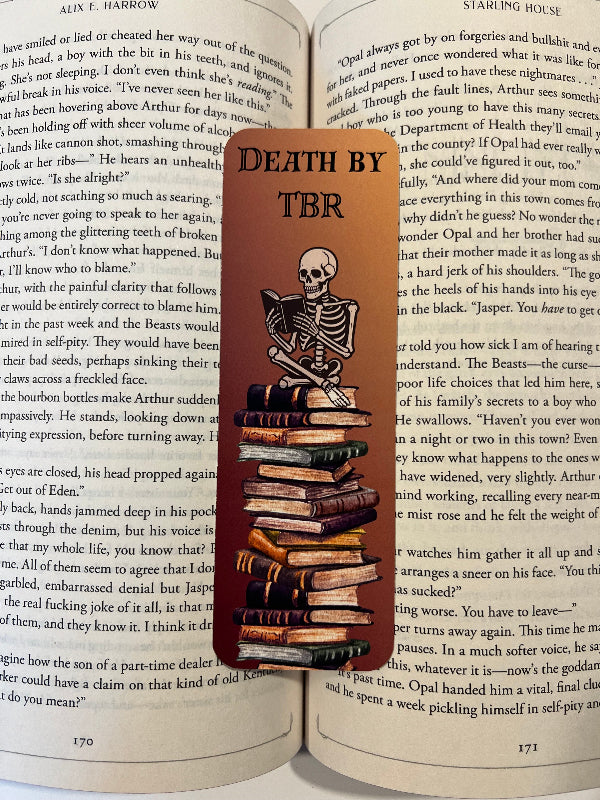 Bookmark with skeleton design and 'TBR' text on an open book