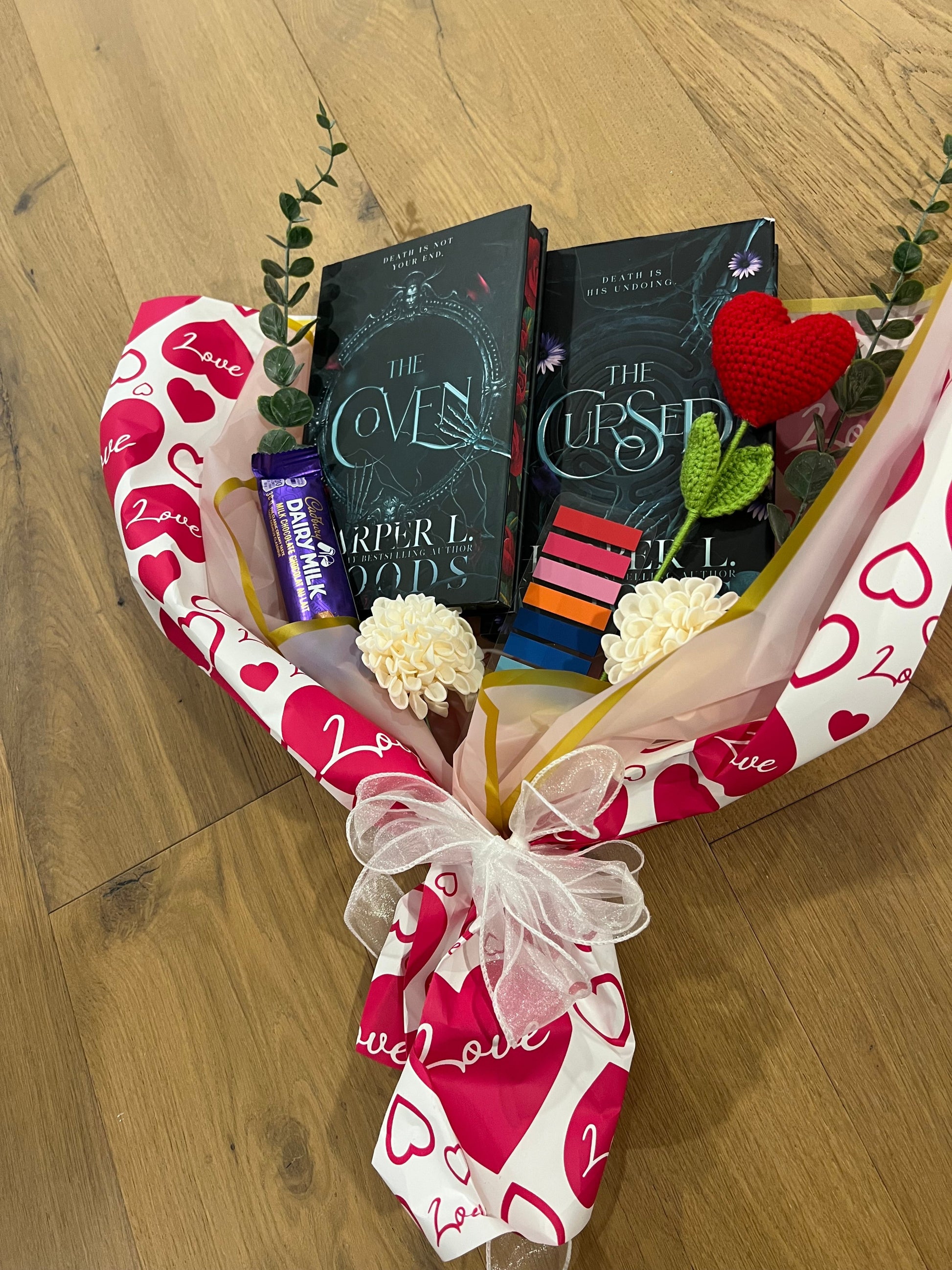 Gift basket with dark romance  books, chocolates, and flowers