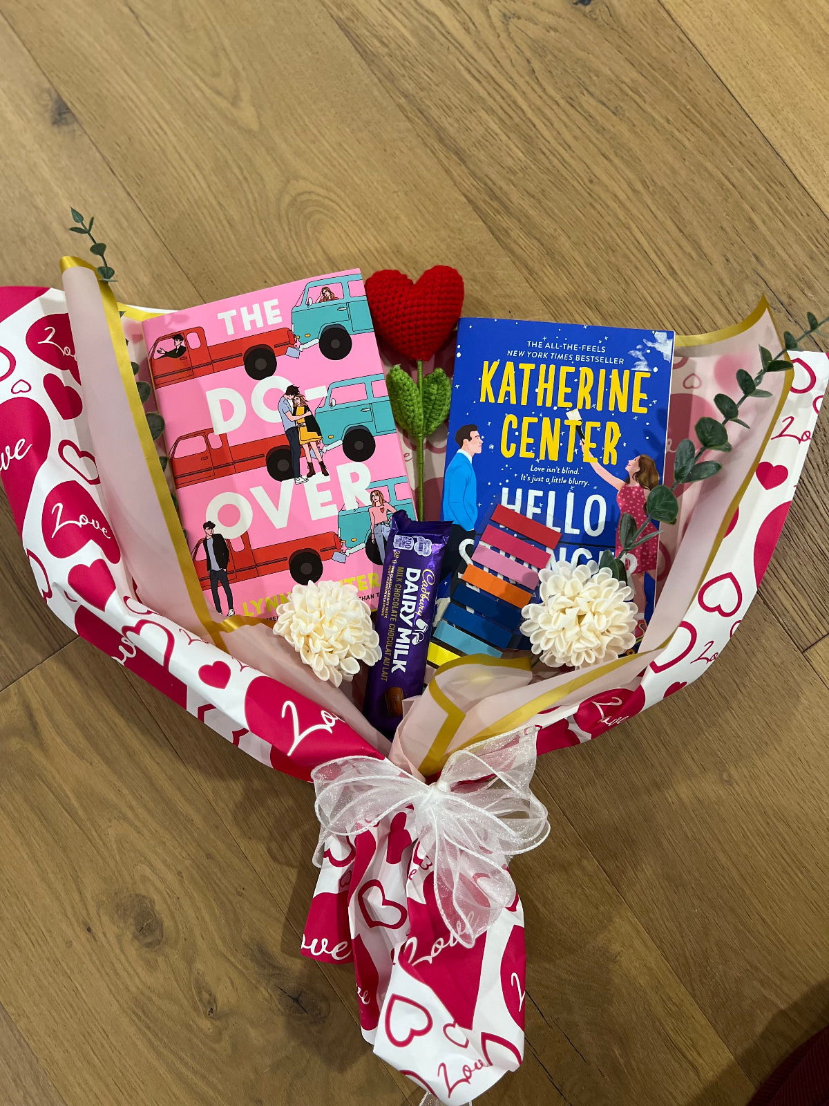 Bouquet of romance books and chocolate arranged like a flower 