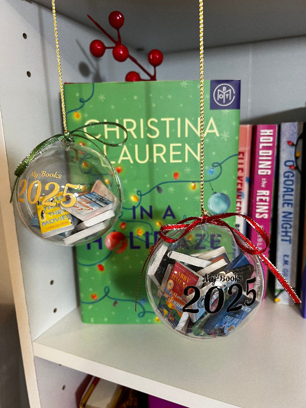 Two decorative ornaments with '2025' and book images on a shelf with books in the background.